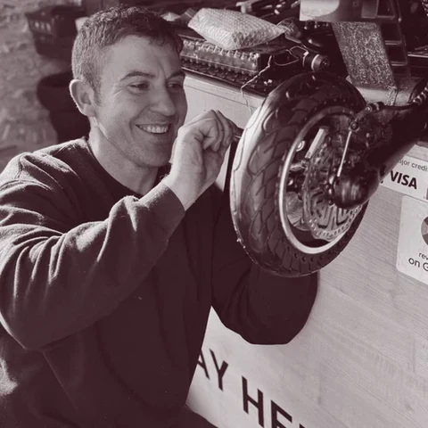 Pascual Soares repairing an e-scooter wheel in the Scoot City workshop