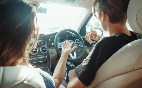 Driving instructor in the passenger seat beside a learner driver