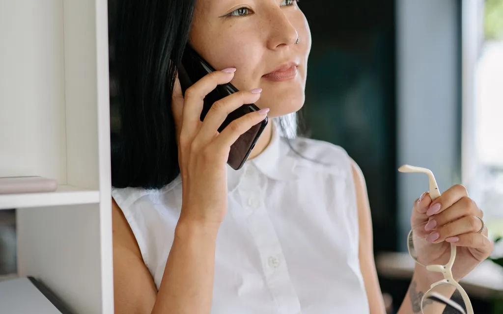 Estate agent taking a call on a mobile phone in the office