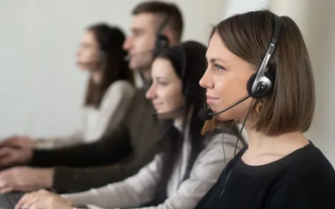 A friendly professional wearing a headset answering calls in a bright modern office
